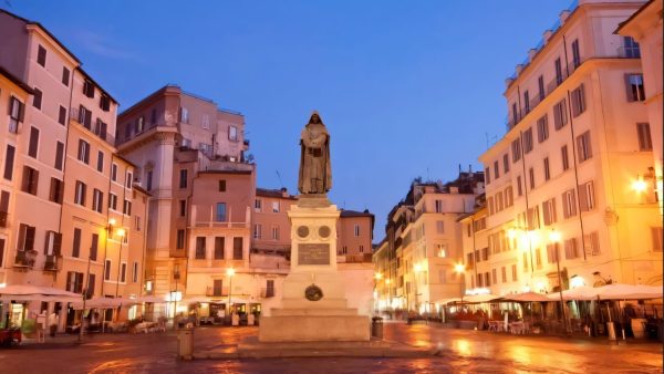 The Statue of Pasquino in a square in central Rome at dusk, a historic symbol of free expression and critical thinking.