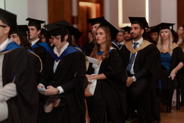 Graduates of the Class of 2026 stand for the academic procession at Town Hall by Bottaccio — European School of Economics Graduation Ceremony, London, 4th July 2026.