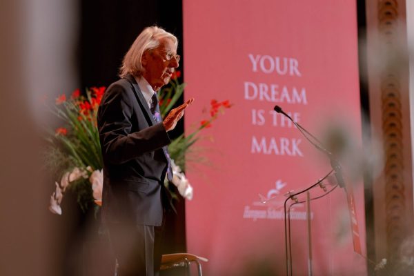 Elio D'Anna, ESE President and Founder, addresses the graduating class beneath the ceremony's theme, 