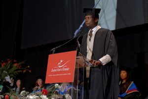 Oluwafemi delivers his testimonial during the ESE Graduation Ceremony at Town Hall by Bottaccio, London.