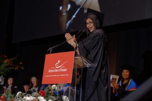 A graduate addresses her fellow classmates and Yhanks the ESE community during the Graduation Ceremony, Town Hall by Bottaccio.